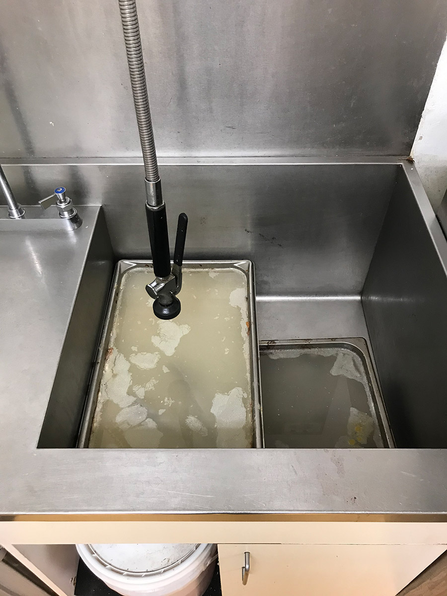 3 hotel pan trays of creamy fluid soaking over the weekend waiting for the first kitchen volunteer shift of the week to clean it