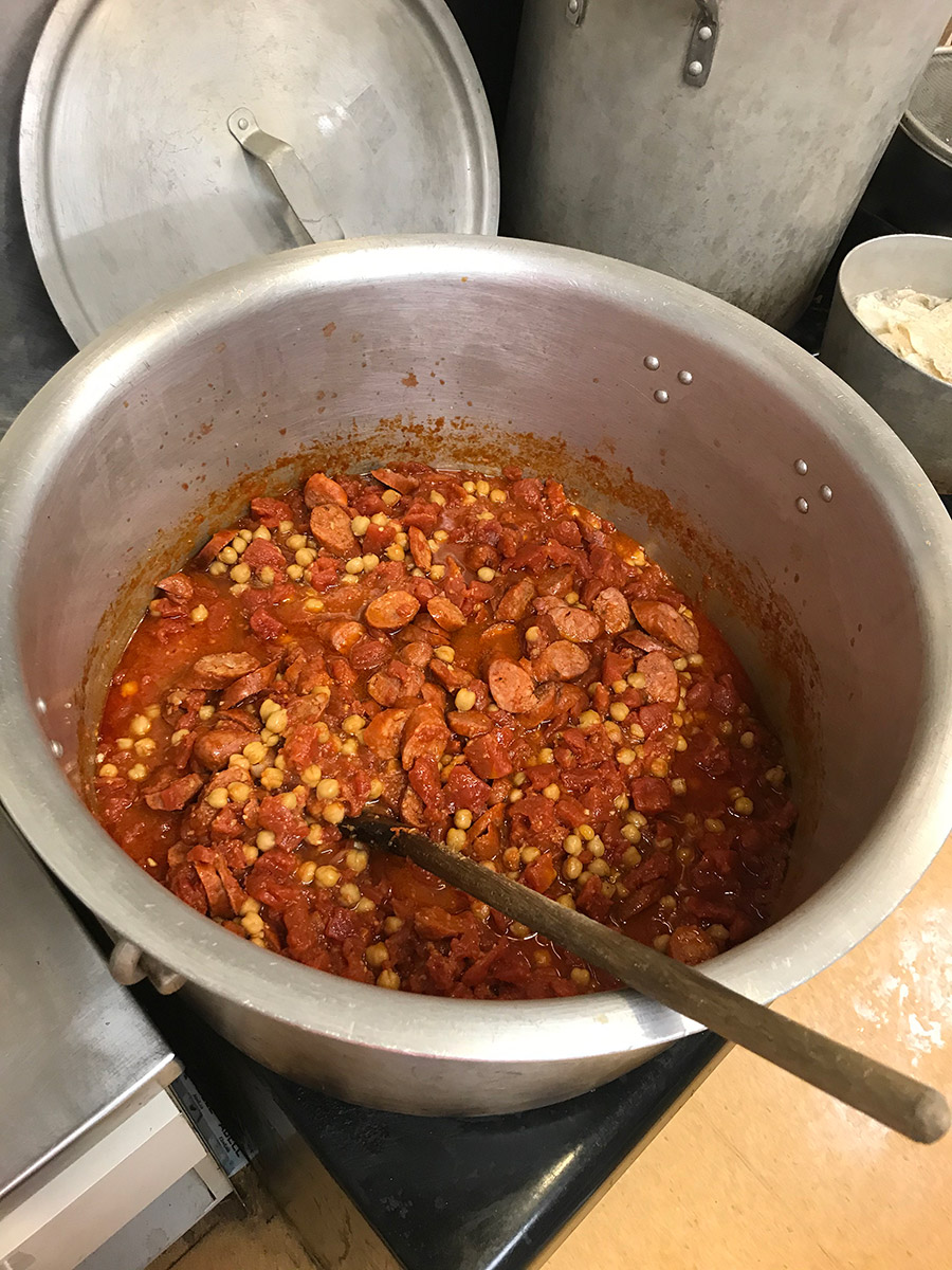a 30 litres pot with tomato and chorizo based strew with chickpeas