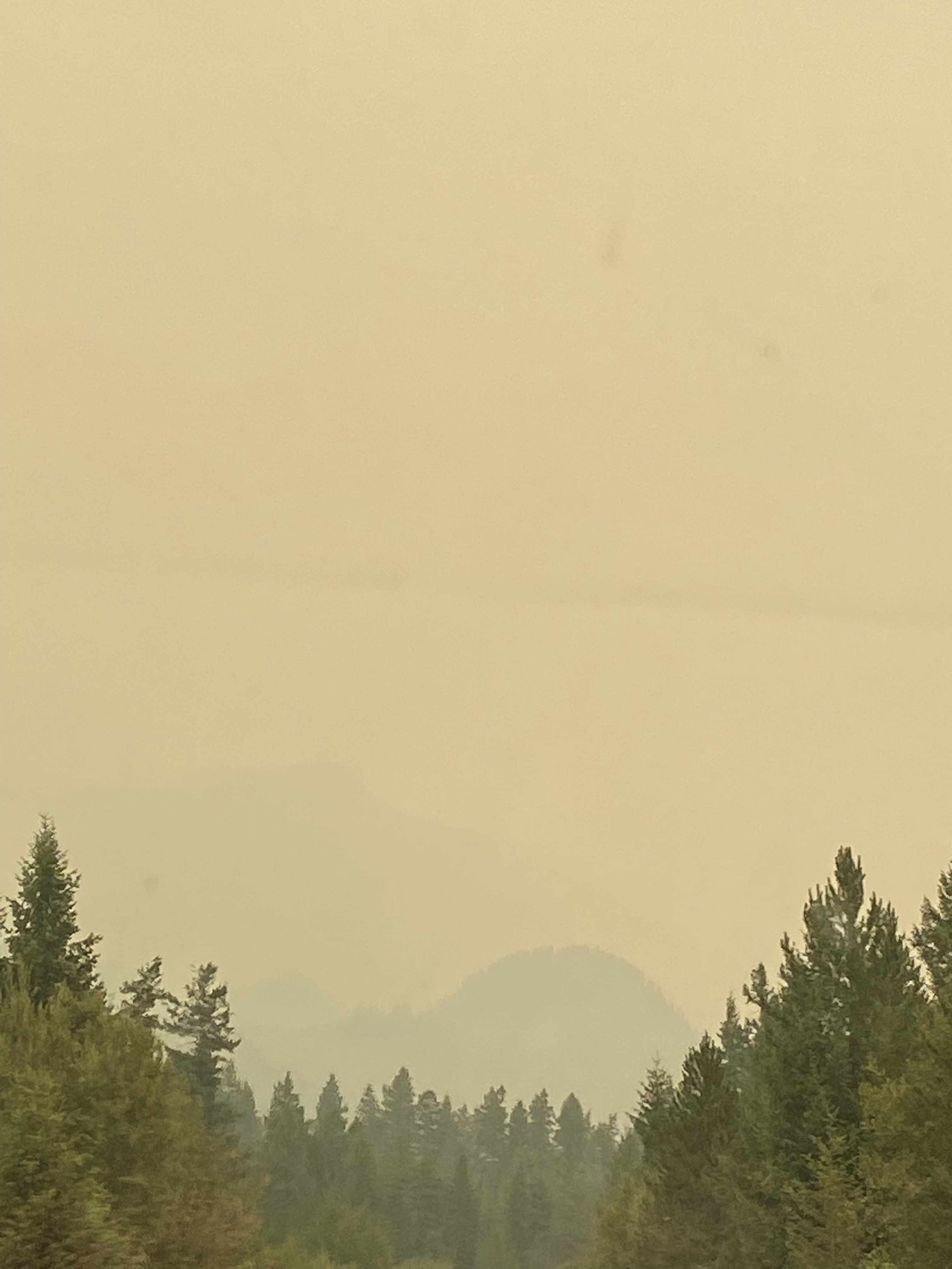 a smoky landscape makes the mouantin in the distance of this image very fuzzy